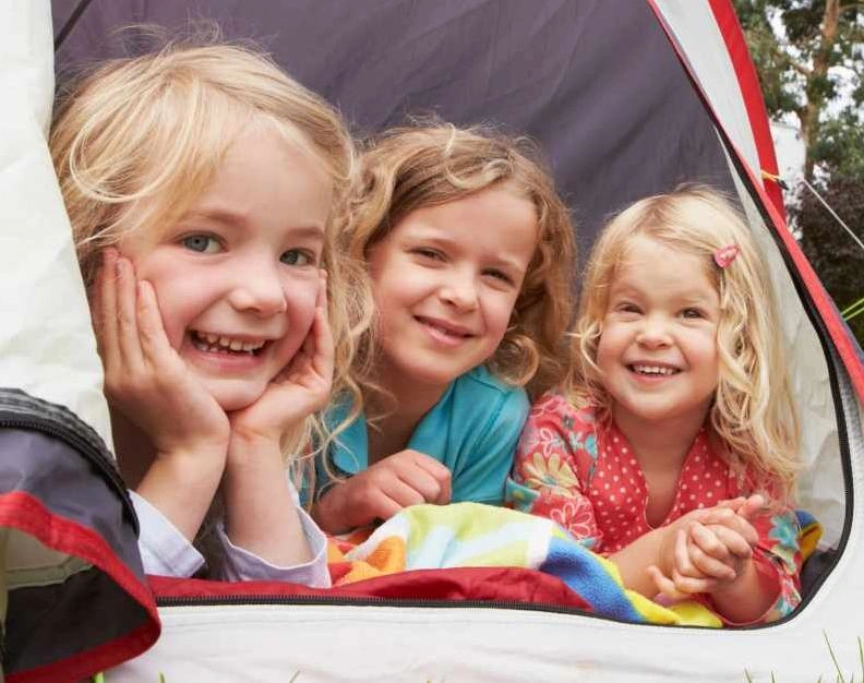 Little girls enjoy their temperate north american camping experience