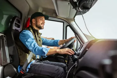 Canadian commercial driver operating a truck while following safe driving schedules.