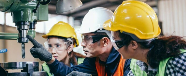 - BIS Safety Software Asian male foreman manager showing case study of factory machine