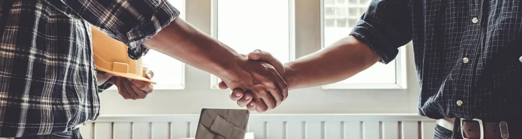 Engineer and contractor shaking hands success of the project work together