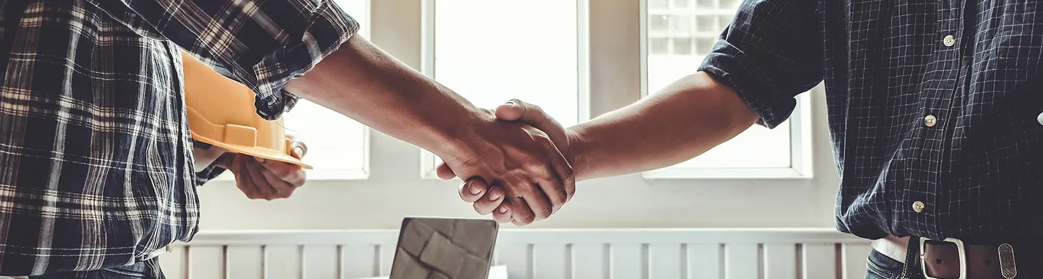 Engineer and contractor shaking hands success of the project work together