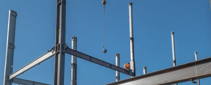 - BIS Safety Software 2 ironworkers are on a horizontal steel I-beam just put into pla