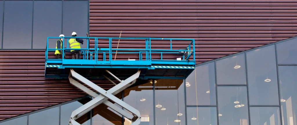 Builder on a Scissor Lift Platform at a construction site