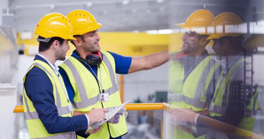 Two EHS consultants discuss the emergency health and safety plans.