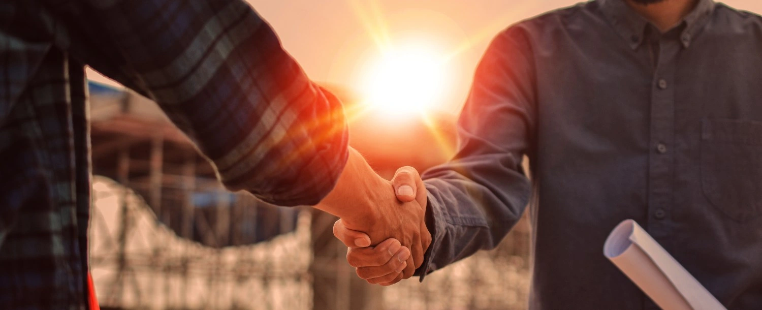 Business handshake during sunset meeting
