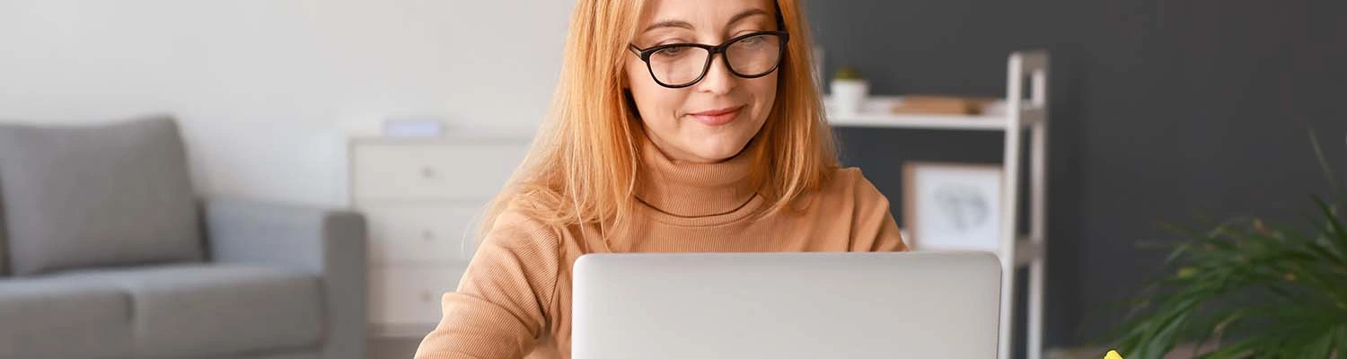 woman using laptop for online learning at home cropped