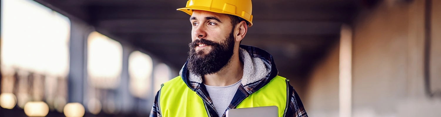 construction guy holding competency management software