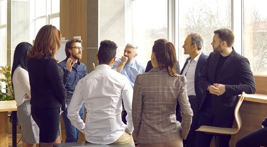 - BIS Safety Software Business coach meeting with group of people in modern office interior. Team of workers listening to teacher's inspirational speech during creative business training class. Banner, header background