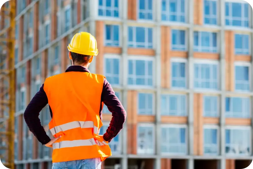 A Construction Worker standing in front of a site.