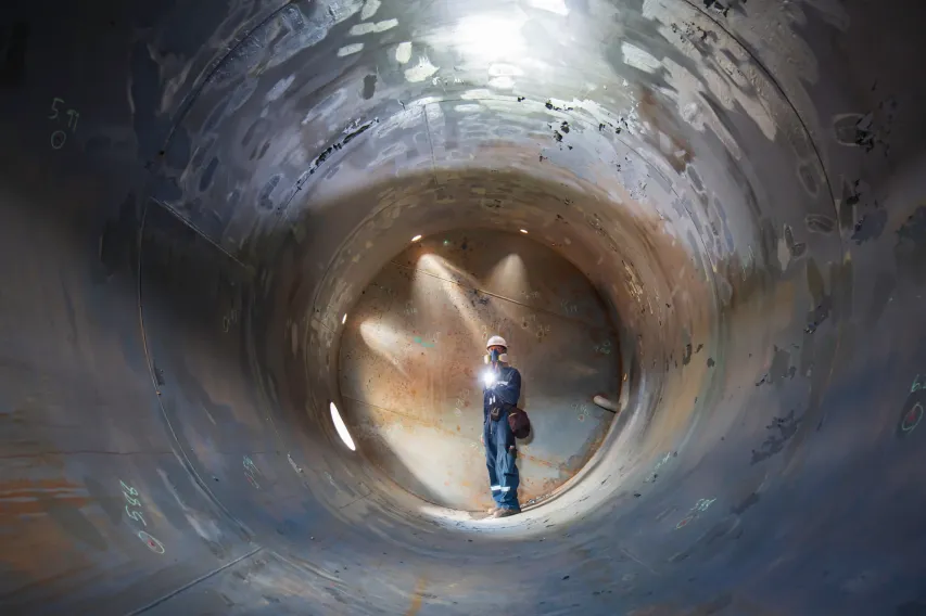 Trainee demonstrates confined space entry preparation, ensuring compliance and safety training