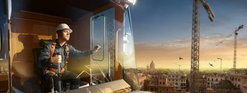 Engineer operator crane in action . He sit a top in crane cabin and working. Around beautiful sunset