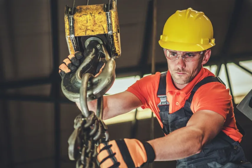 - BIS Safety Software Caucasian Warehouse Lift Operator in His 30s. Heavy Duty Lifting Equipment.