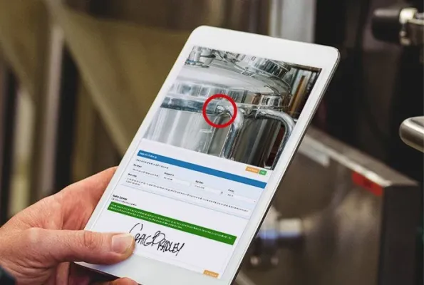 Man in brewery with inspection tablet Image for COR landing page smaller