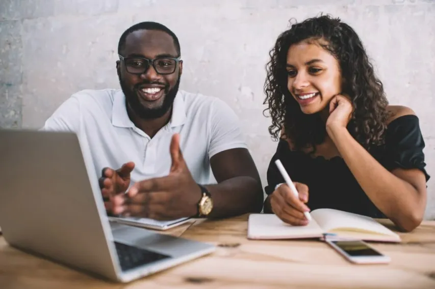 - BIS Safety Software Cheerful african american male and female colleagues discussing project ideas making research on laptop computer, smiling dark skinned man explaining information to female student via webinar