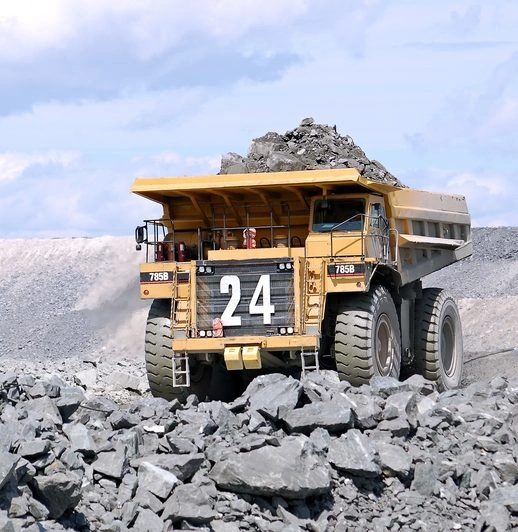 A Mega truck carrying load of rocks at a mining site