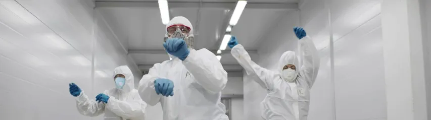 - BIS Safety Software Team of medical workers in hazmat suits dancing and walking in hospital corridor. Funny disinfectors in respiratory mask and protective uniform dancing celebrating end of epidemic
