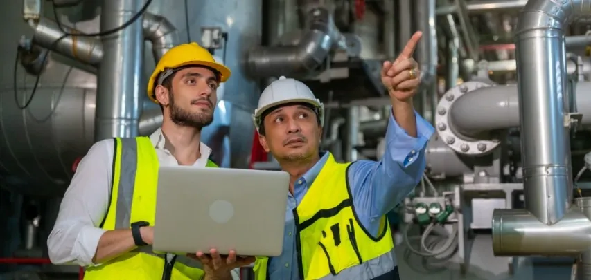 - BIS Safety Software Two Employees point out things that require a corrective action plan in an energy refining plant.